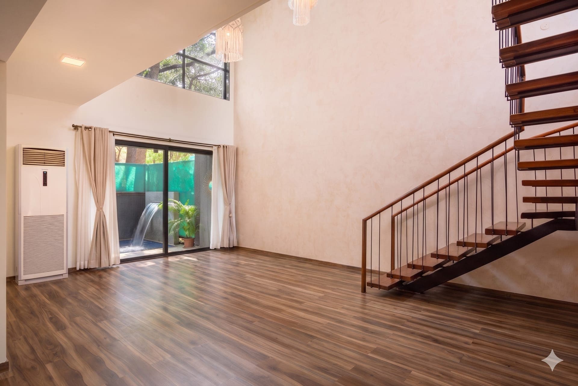 A Nistula villa room before styling — a bare double-height space with empty floor and walls.
