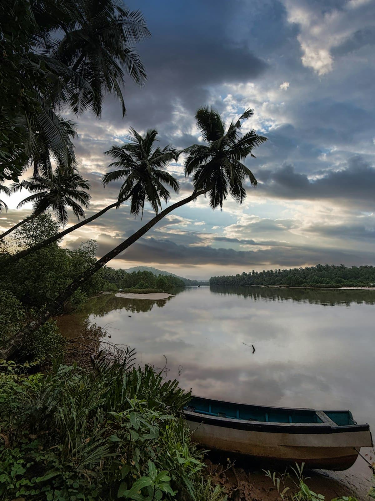 The Chapora river at dusk with a moored boat.
