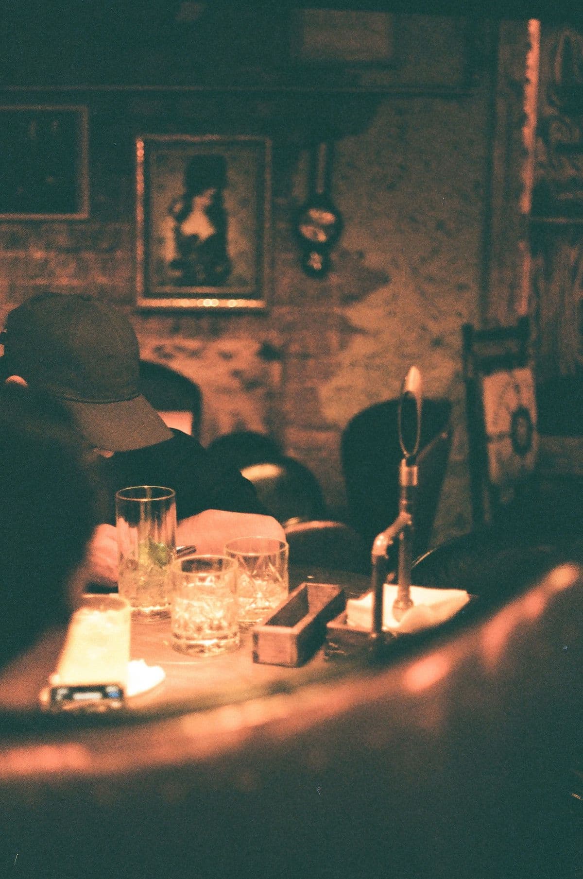 An intimate, art-filled cocktail bar at night.