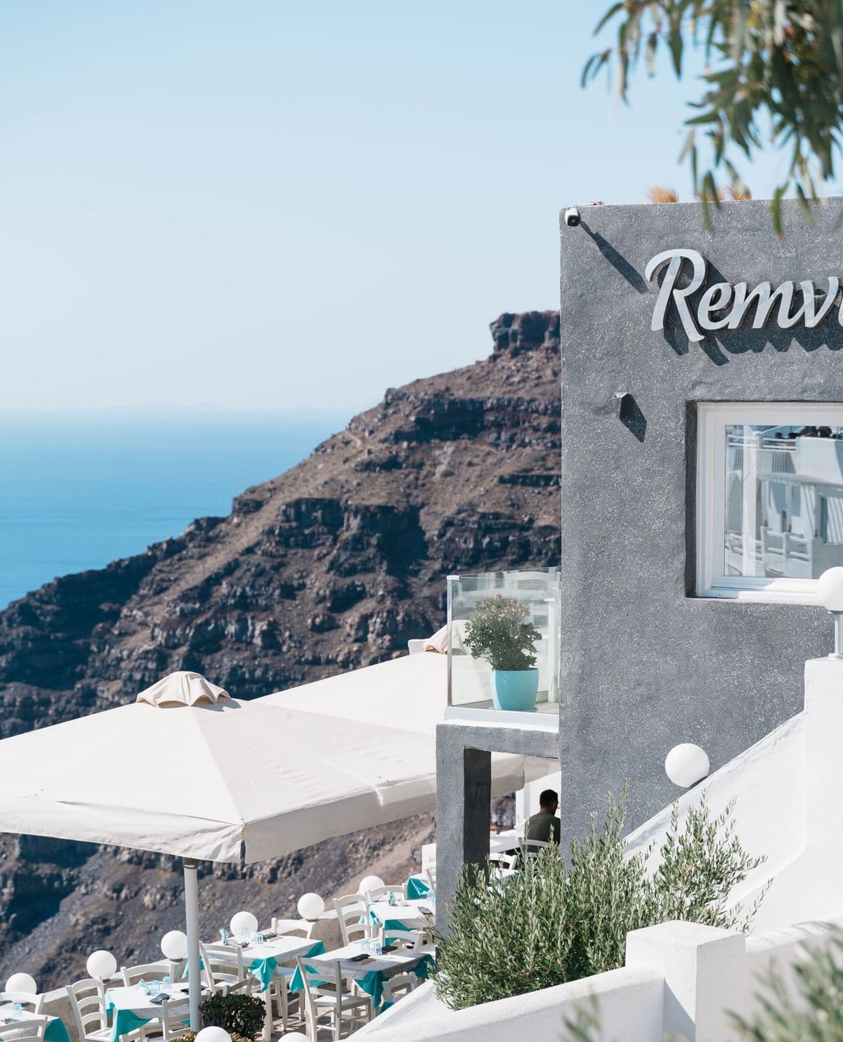 A blue-and-white terrace restaurant with a sea view.